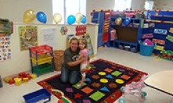 Teacher and Student Hugging In Play Area