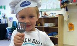 Young Boy Wearing a Chef's Cap and Spatula