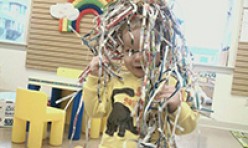 Child Covered in Fun Paper Strips