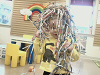 Child Covered in Fun Paper Strips